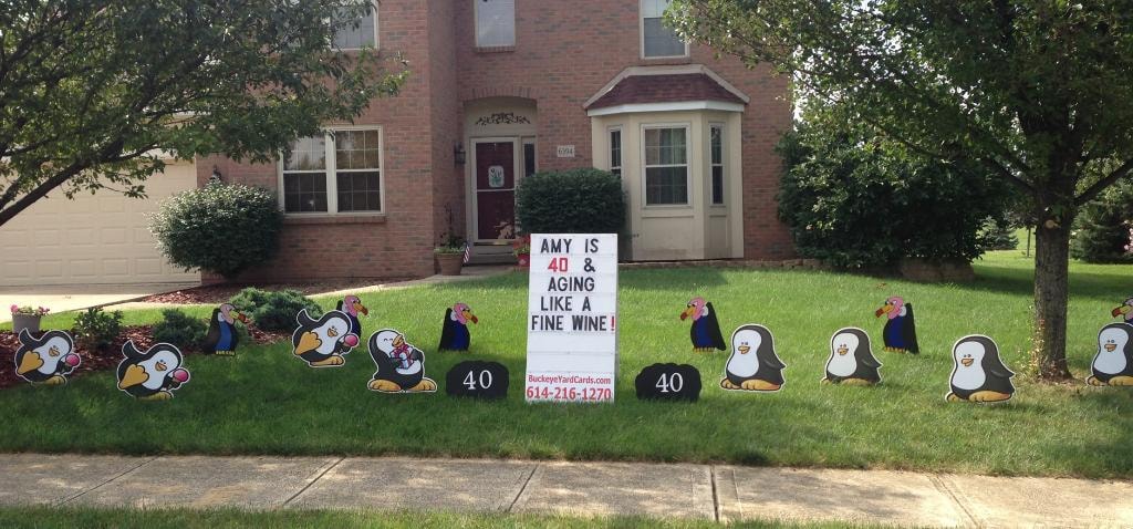 Penguin yard signs for Amy's 40th birthday aging like a fine wine