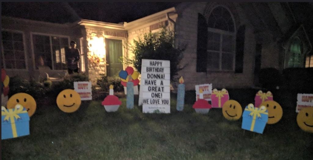 Birthday yard sign display with smiley faces for Donna