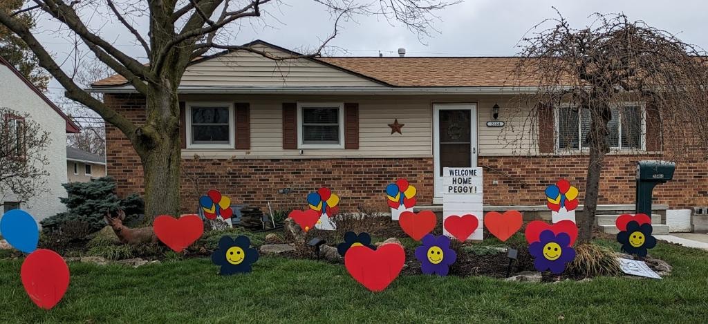 Colorful yard decorations welcoming Peggy home