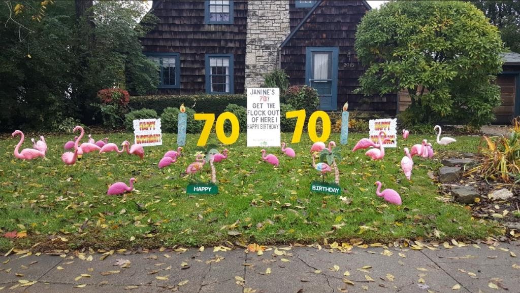 Shingle cottage home with flamingos and gold 70 signs for Janine's 70th birthday