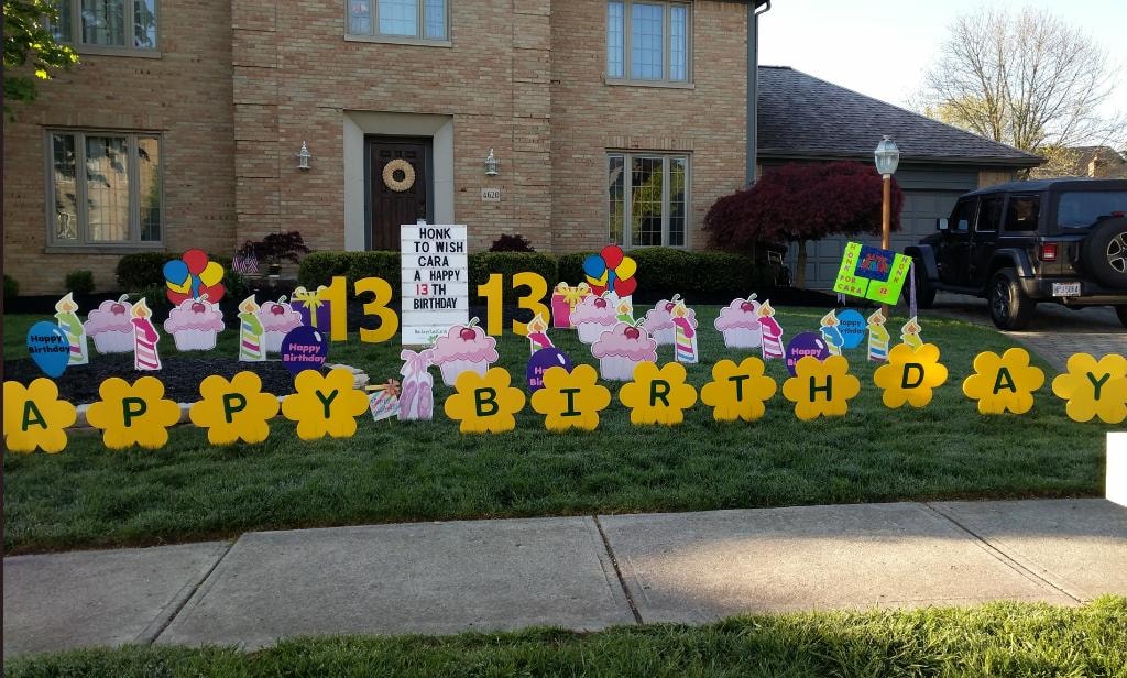 Colorful flower birthday yard sign display for Cara's 13th birthday