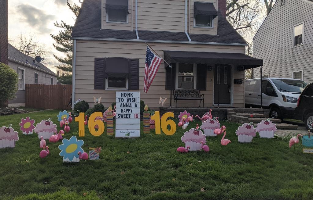 Front yard with flamingos cupcakes and number 16 signs for Anna's Sweet 16