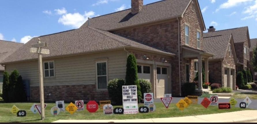 House decorated with road signs for Tom's 60th birthday