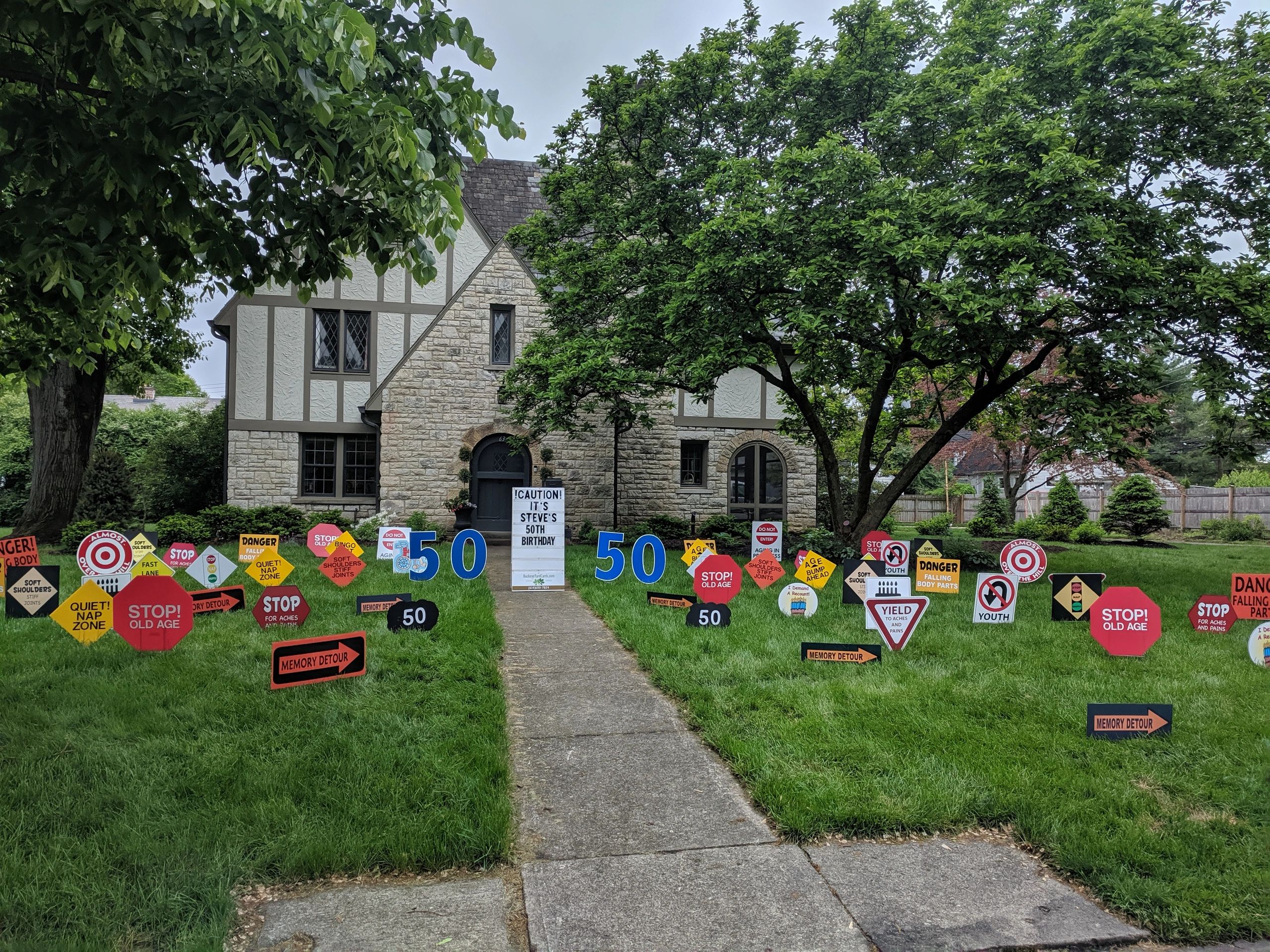 Tudor home with road sign 50th birthday display