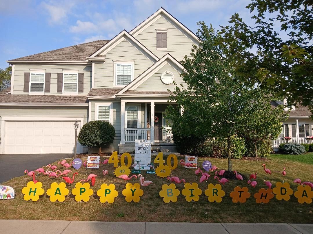 Colonial house with flamingo 40th birthday yard display