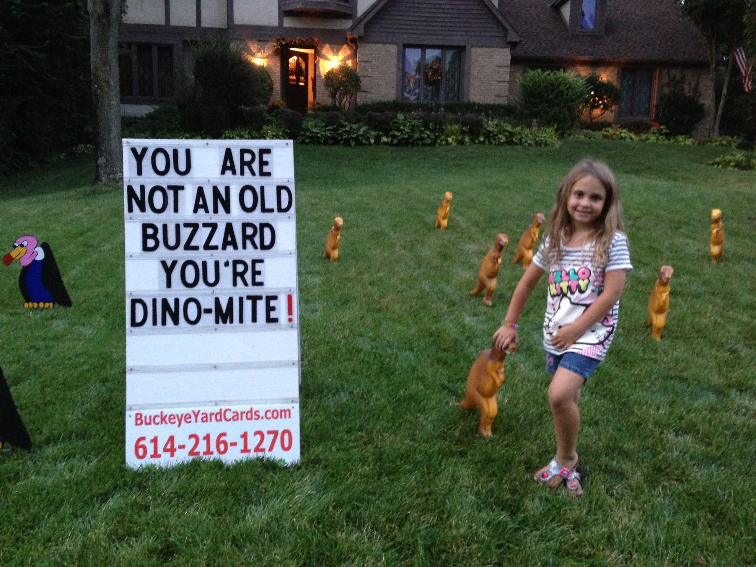 Girl with dinosaur birthday yard card display